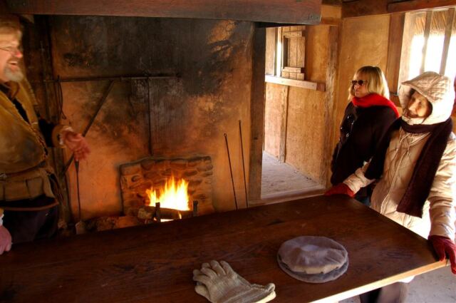 Kathy and Geri listen while warming by the fire