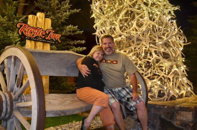 Kathy and Roger under lit Elk antler arch