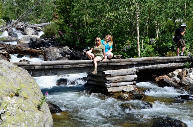 Kathy and Mel over a Teton stream