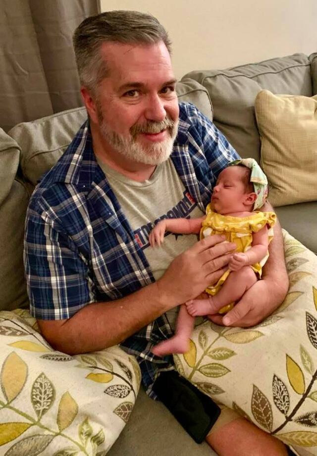 Grandpa holding sleeping Madi