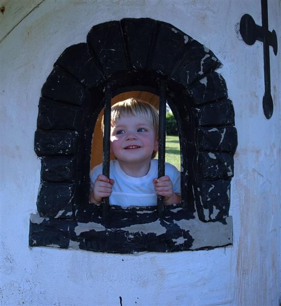 Sam peeks through the bars