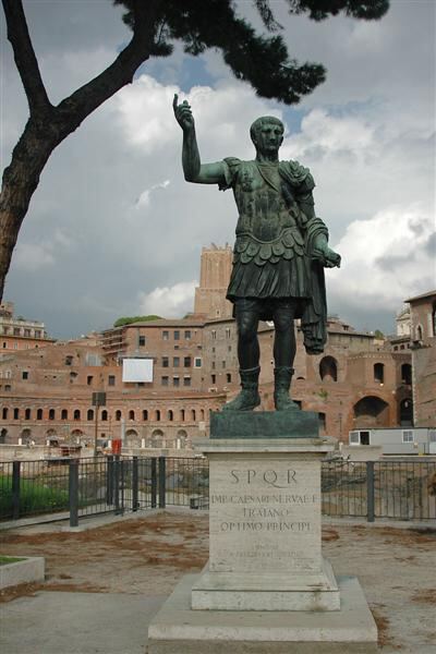 Caesar statue and ruins in background