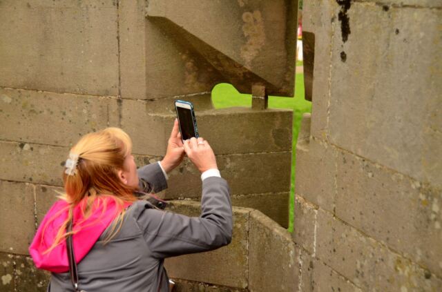 Warwick Castle - LeAnn takes a picture through the arrow slits
