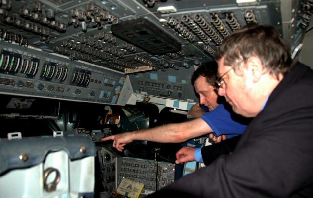 Matt shows John some of the details of the Space Shuttle cockpit