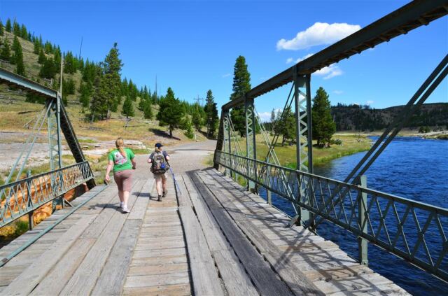Mel and Kathy cross the trailhead bridge