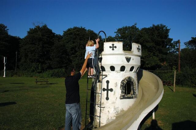 Andrew helps Sam onto the castle slide