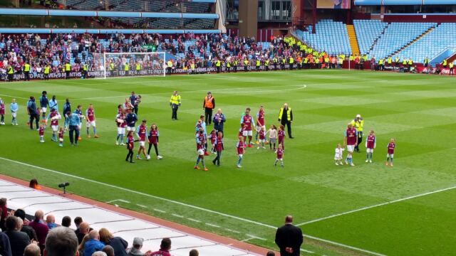 Villa players and managers salute the crowd post-match