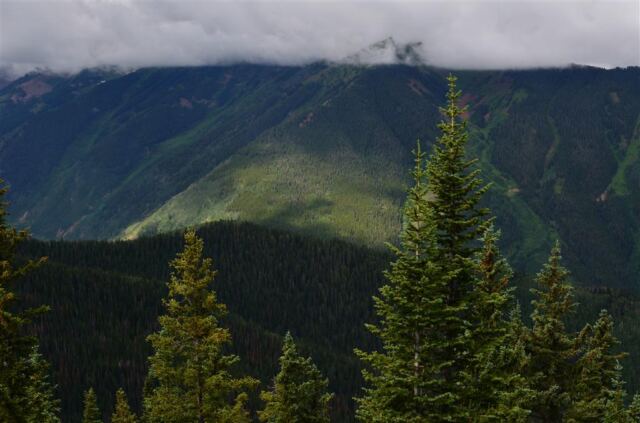 A low cloud hugs the top of Aspen Mountain