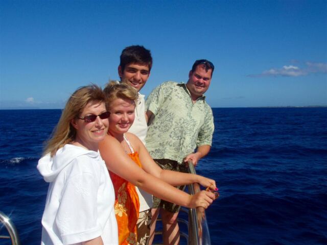 PO - LeAnn, Melanie, Andrew, and Tim at the front of the catamaran