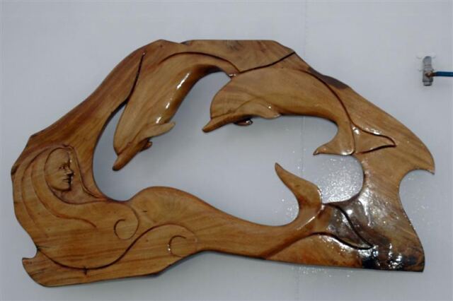 Mermaid and dolphins aboard Voyager