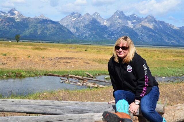Kathy relaxes on a log