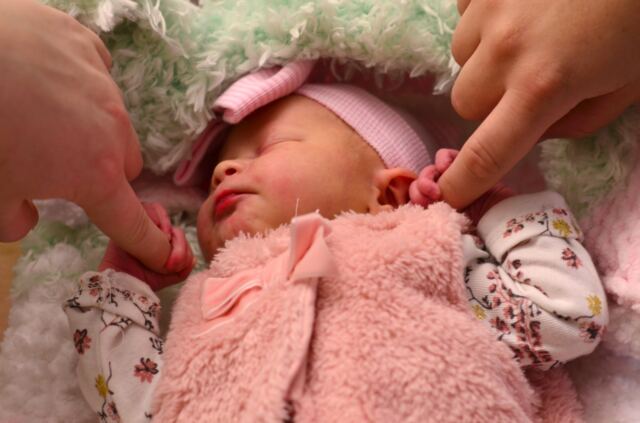 Shiloh-holding-Mommy-and-Daddy-s-fingers