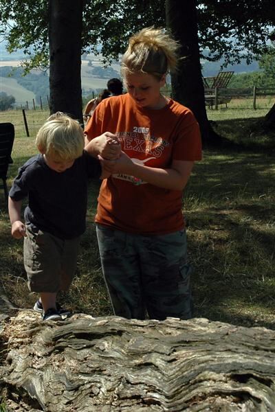 Melanie helps Sam scale the tree trunk