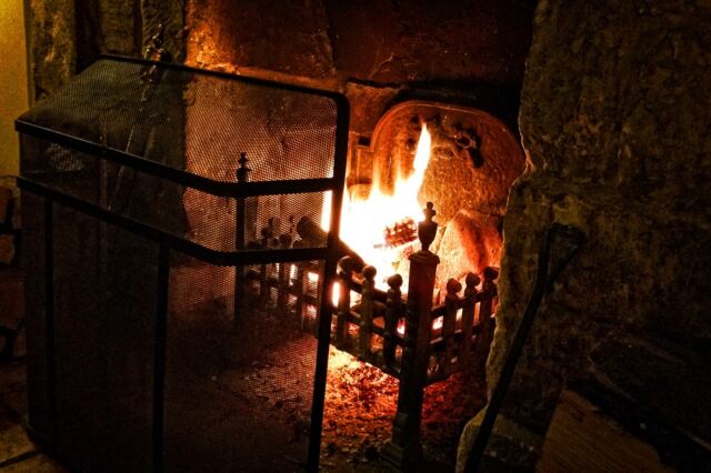 Enjoying a scotch in front of the Charingworth fireplace