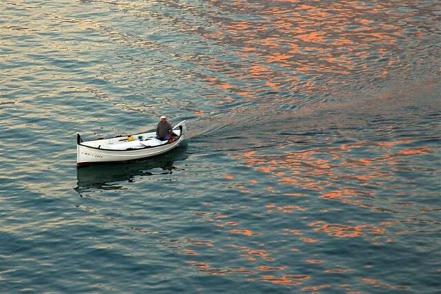 A small boat passes between us and the edge
