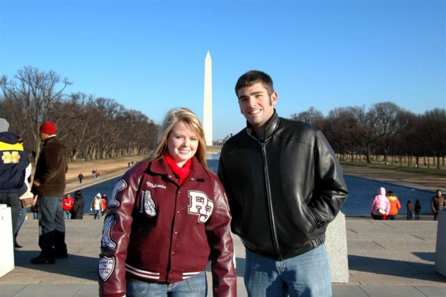 A very cold pair of kids... and a big monument