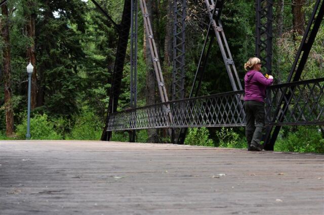 Kathy on bridge overlooking stream