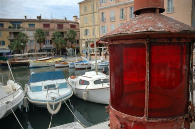 Boats and old lighthouse lamp