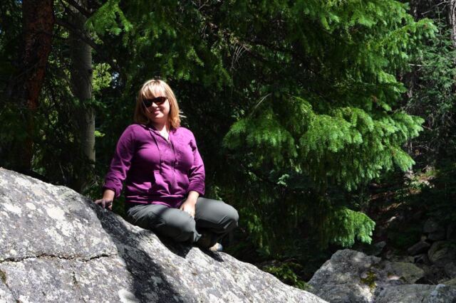Kathy sitting pretty atop a rock