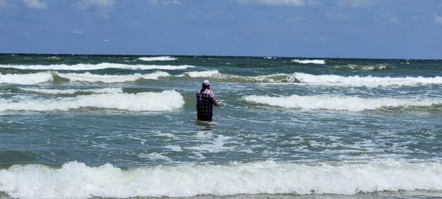 Jarrett casting in the surf