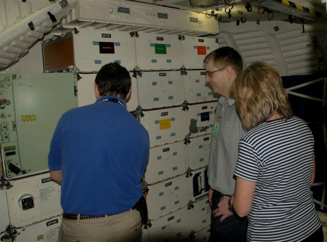 Matt shows Mark and Marianne some of the middeck locker space
