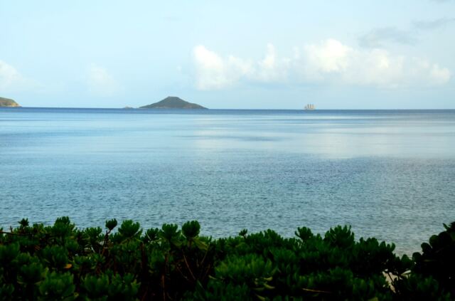 Three-masted schooner on the horizon
